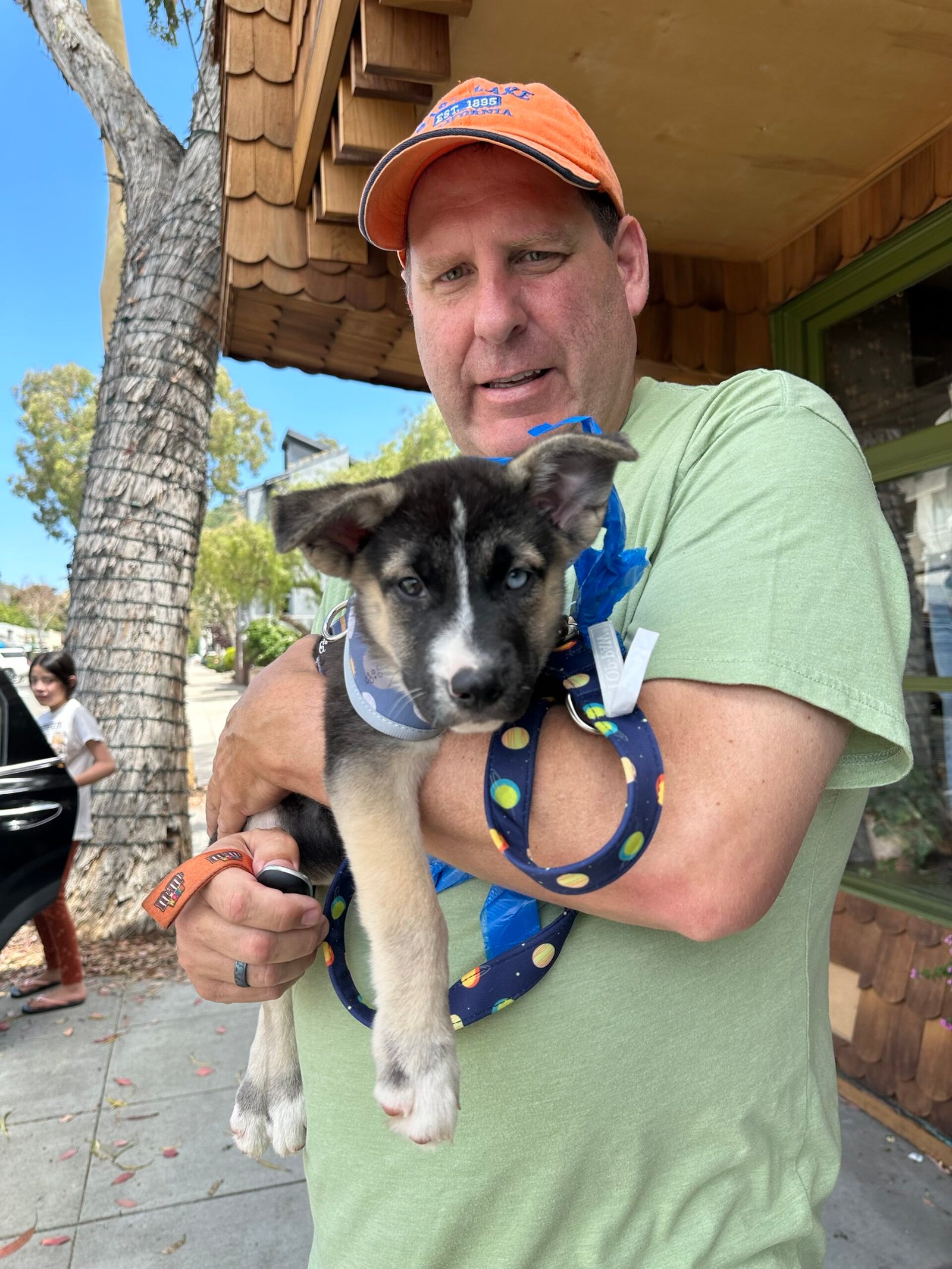 Milo as a puppy, carried like a football